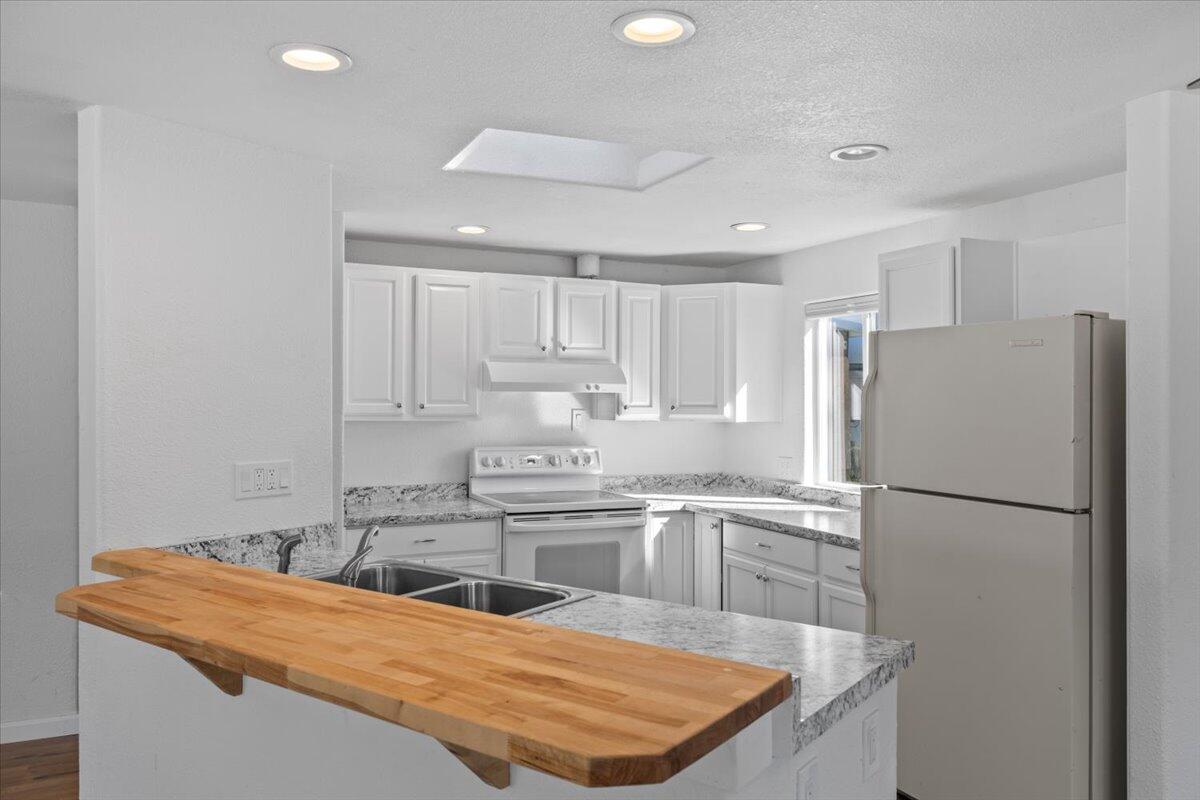 939 South Valley View Road, Unit 12 Ashland, OR 97520 - Photo 6 of 19 a kitchen with stainless steel appliances granite countertop a sink a refrigerator and a stove