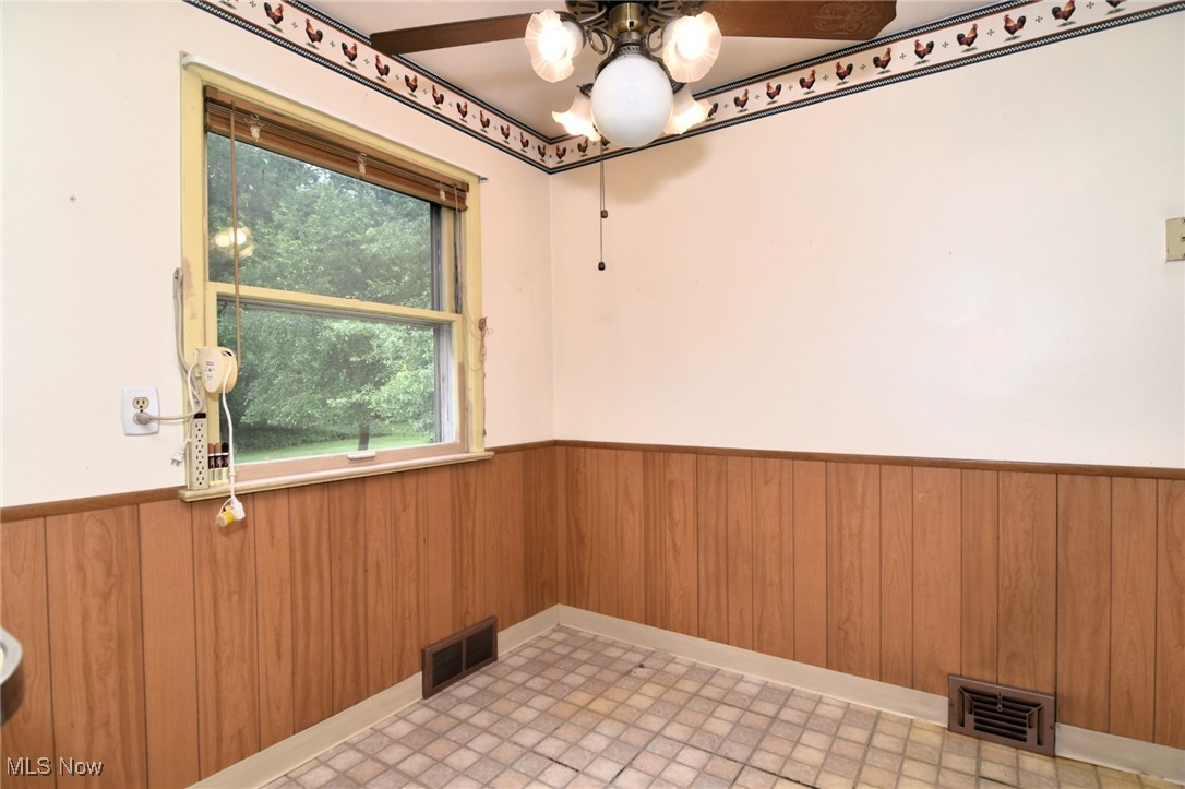 9421 David Road Cleveland, OH 44125 - Photo 12 of 36 Spare room with wainscoting and wood walls