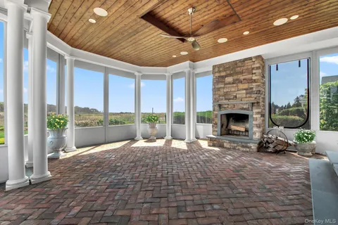 a view of living room with furniture tv and floor to ceiling window