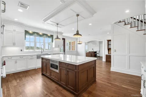 a kitchen with a stove window and wooden floor