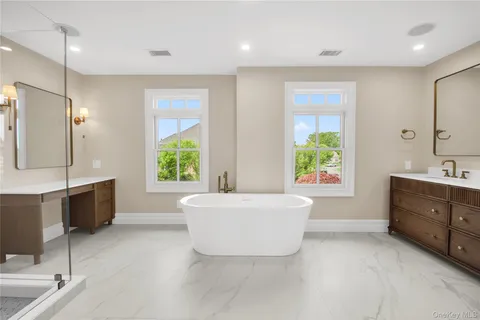 a spacious bathroom with a large tub shower and windows