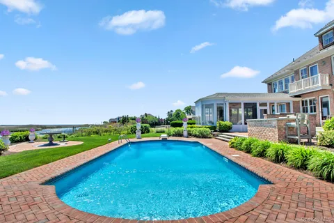 a view of a swimming pool with an outdoor space and seating area