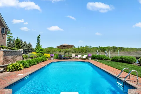a view of swimming pool with outdoor seating and yard