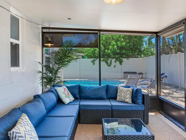 a view of a house with swimming pool and sitting area