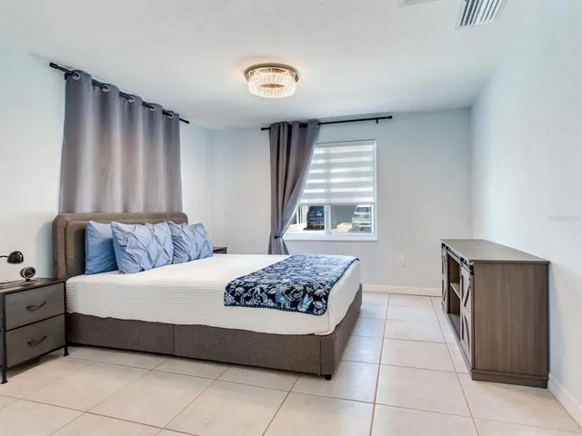 a bedroom with a bed and a window