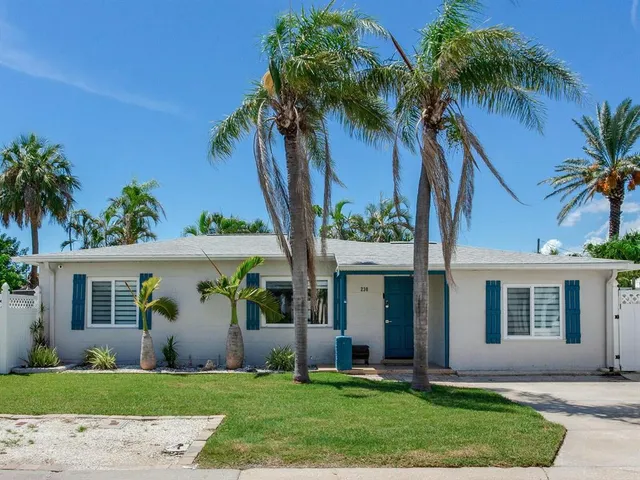 an aerial view of a house with garden space and ocean view