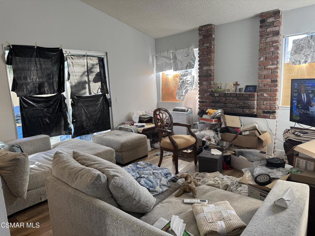 4529 North Canyonlands Road Moorpark, CA 93021 - Photo 3 of 15 a living room with furniture window and a fireplace
