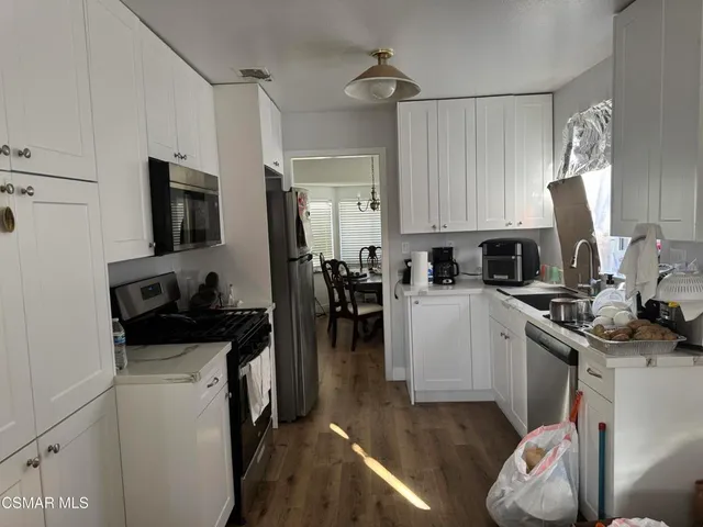 a kitchen with a sink stove and refrigerator