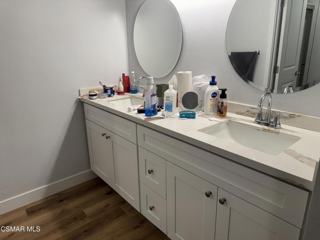 4529 North Canyonlands Road Moorpark, CA 93021 - Photo 7 of 15 a bathroom with a double vanity sink and a mirror