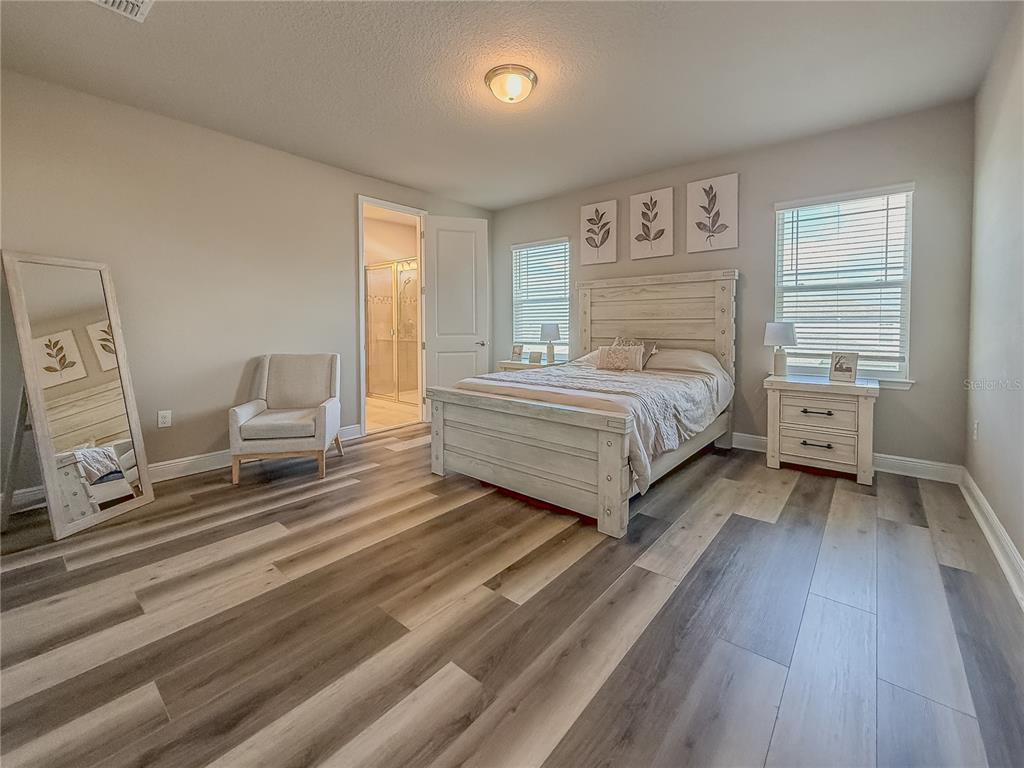 2310 Raven Rdg Drive Minneola, FL 34715 - Photo 11 of 21 a spacious bedroom with a bed and window