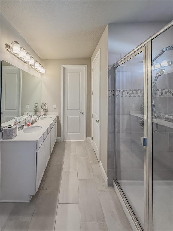 2310 Raven Rdg Drive Minneola, FL 34715 - Photo 13 of 21 a bathroom with a double vanity sink mirror and shower