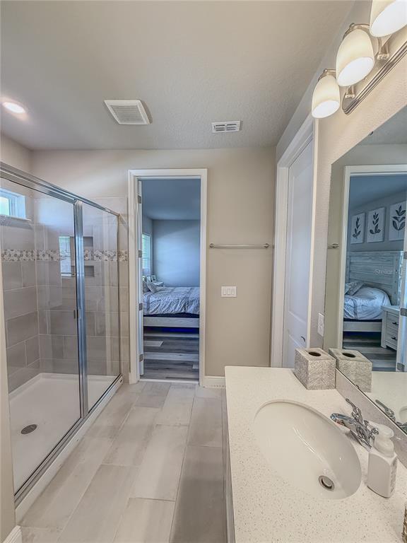 2310 Raven Rdg Drive Minneola, FL 34715 - Photo 14 of 21 a bathroom with a sink a toilet and shower