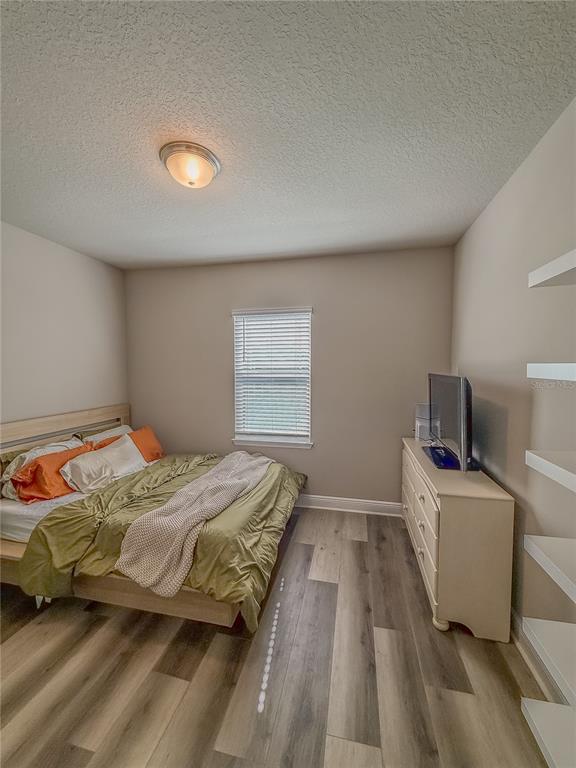 2310 Raven Rdg Drive Minneola, FL 34715 - Photo 15 of 21 a bedroom with a bed and a tv