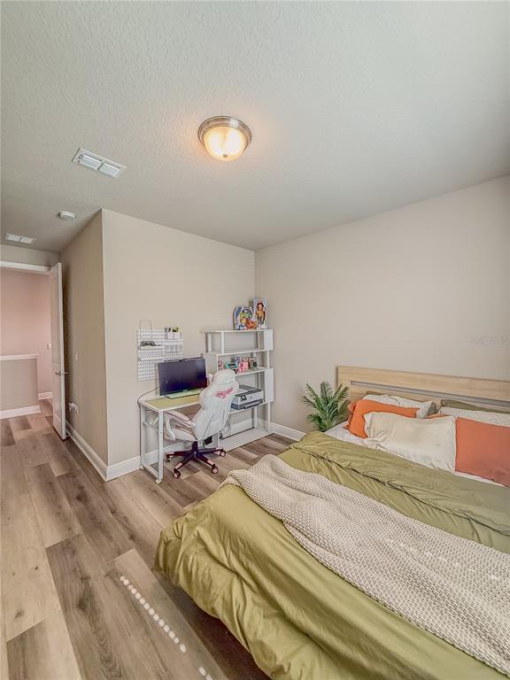 2310 Raven Rdg Drive Minneola, FL 34715 - Photo 18 of 21 a bedroom with a bed and gym equipment