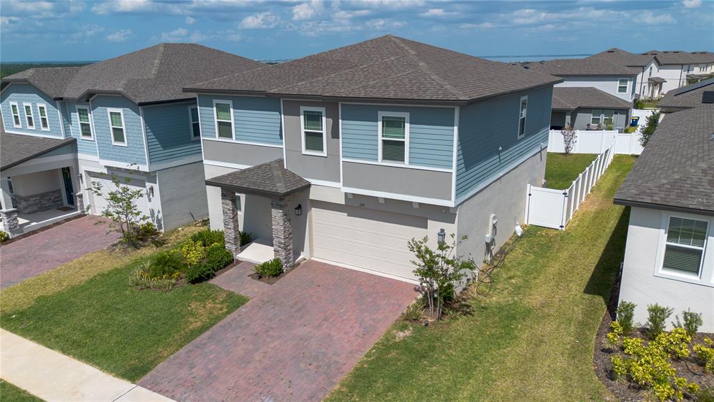 2310 Raven Rdg Drive Minneola, FL 34715 - Photo 3 of 21 a front view of a house with a yard and garage