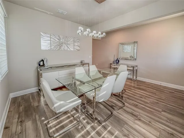 a view of a dining room with furniture and wooden floor