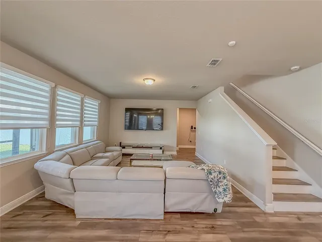 a living room with furniture and a large window