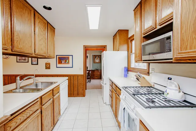 a kitchen with a stove a sink and a refrigerator