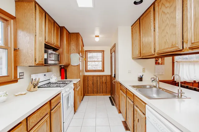 a kitchen with stainless steel appliances a sink stove and cabinets