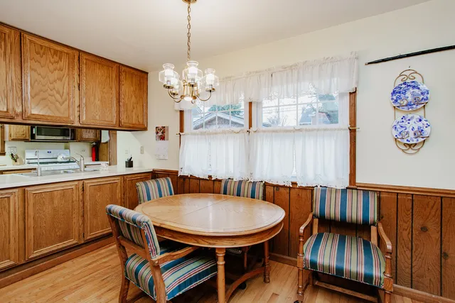 a view of a dining room with furniture wooden floor and a chandelier