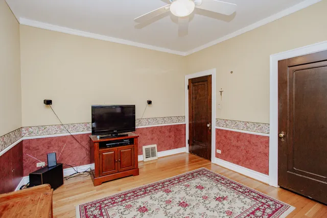 a living room with a flat screen tv and a rug
