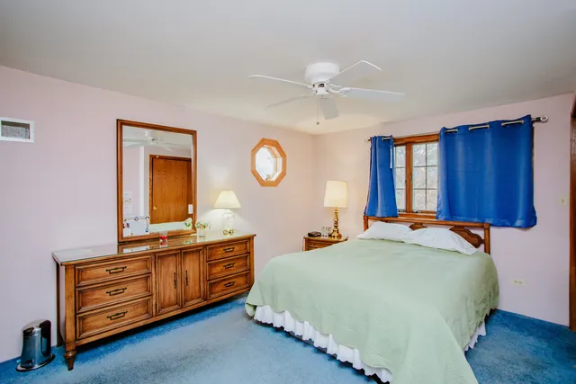 a bedroom with a bed and a dresser