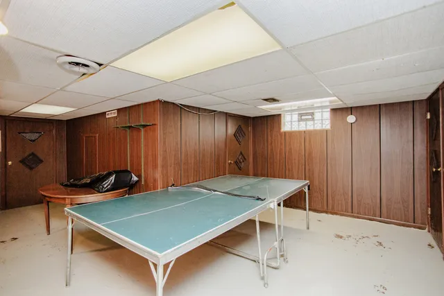 a view of a hallway with closet and wooden door