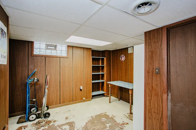 a view of a workspace with furniture and wooden floor