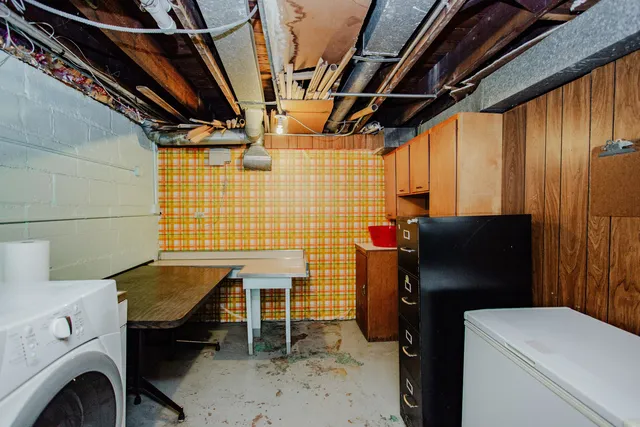 a white house that has a tree in front of it