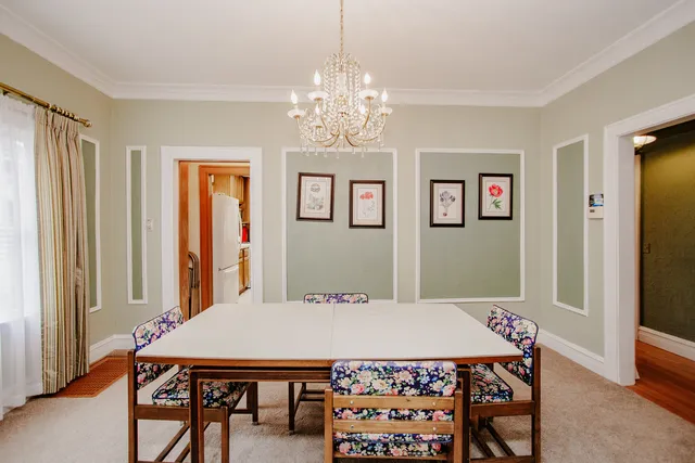 a view of a dining room with furniture and window