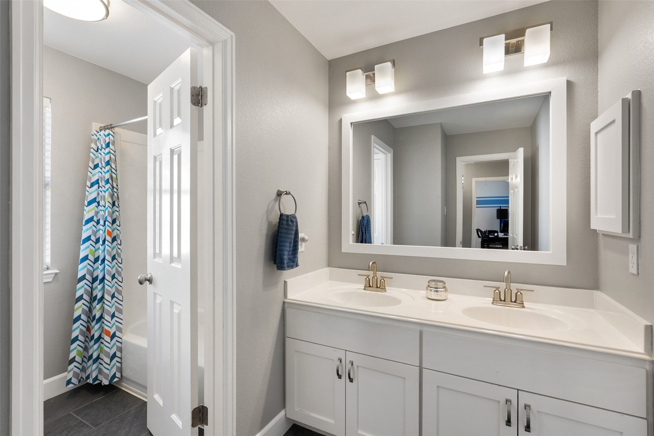 12510 Bright Sky Overlook Austin, TX 78732 - Photo 23 of 39 a bathroom with a sink a vanity and a mirror