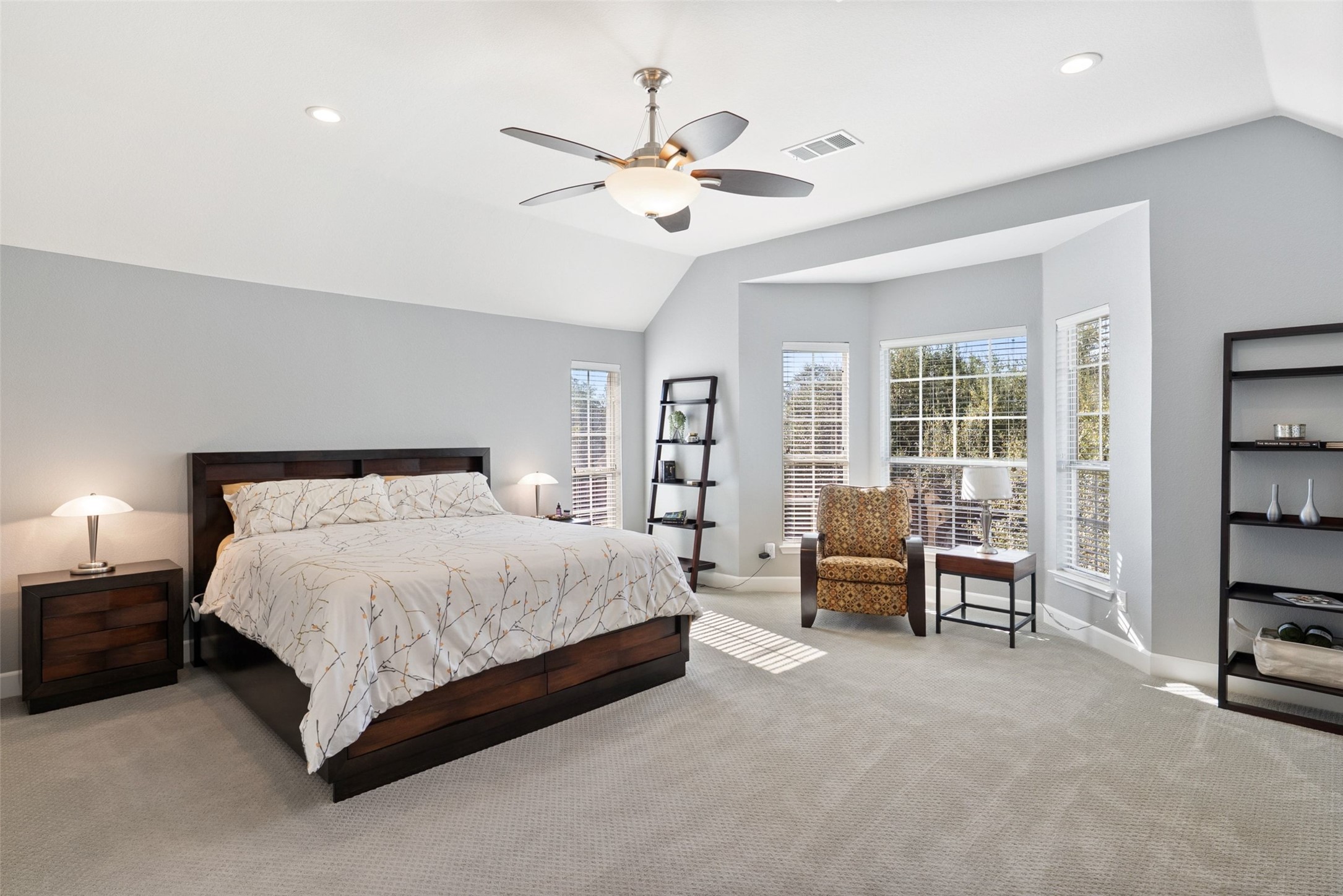 12510 Bright Sky Overlook Austin, TX 78732 - Photo 27 of 39 a spacious bedroom with a bed and a couch