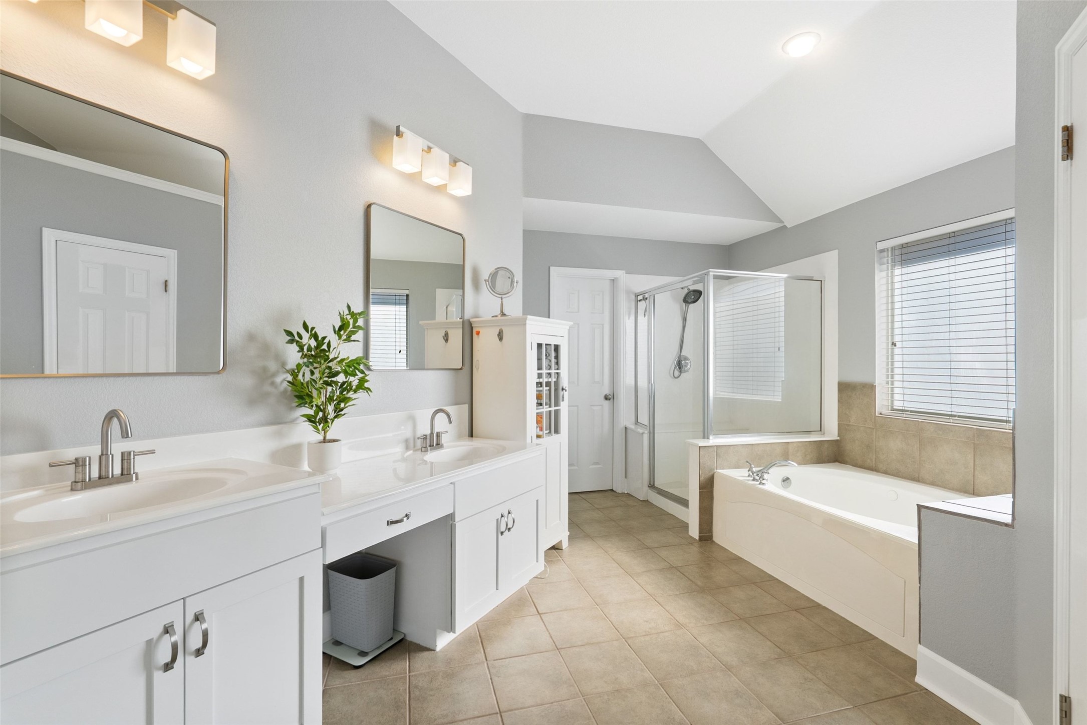 12510 Bright Sky Overlook Austin, TX 78732 - Photo 30 of 39 a bathroom with a tub a sink and mirror