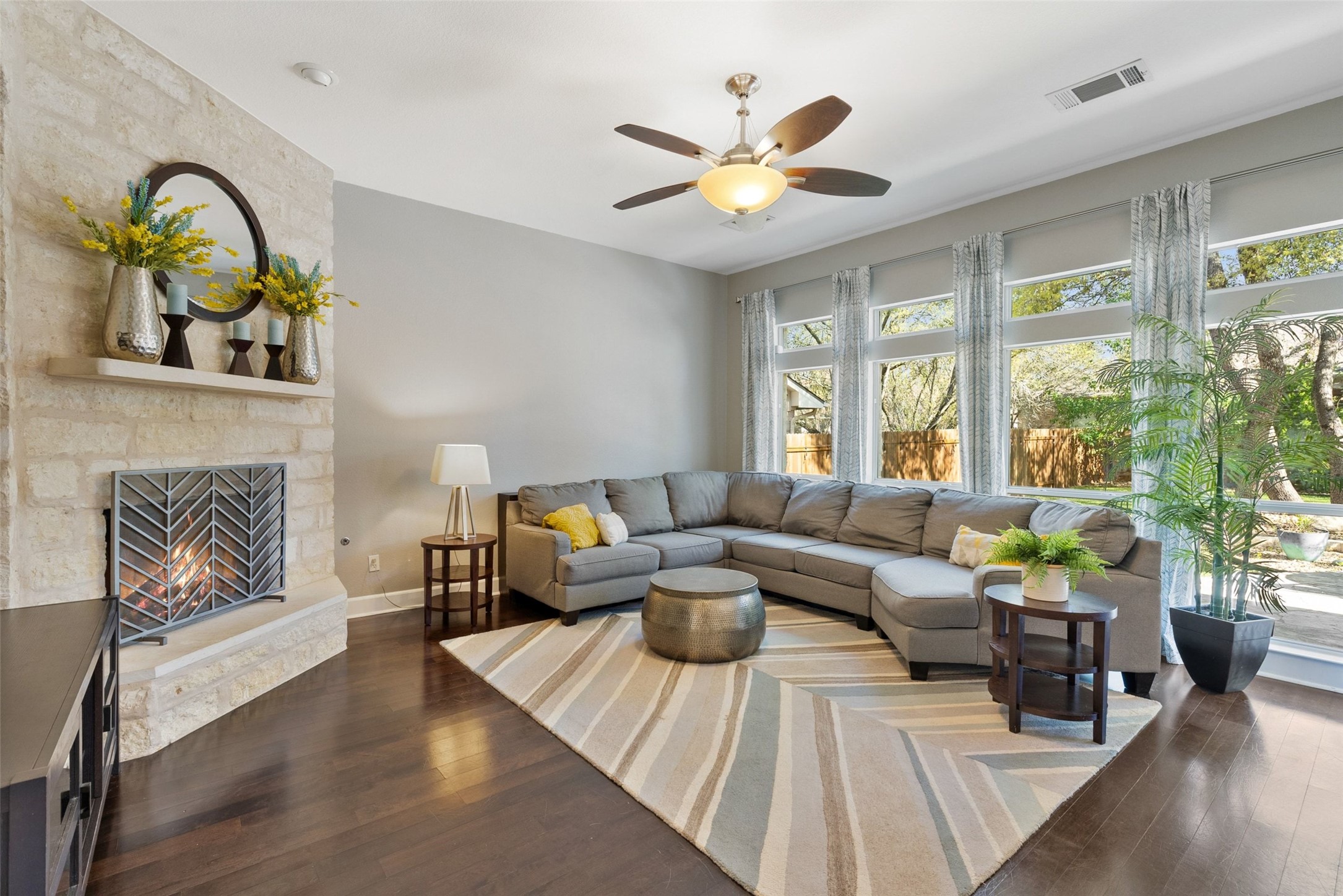 12510 Bright Sky Overlook Austin, TX 78732 - Photo 7 of 39 a living room with furniture a fireplace and a floor to ceiling window