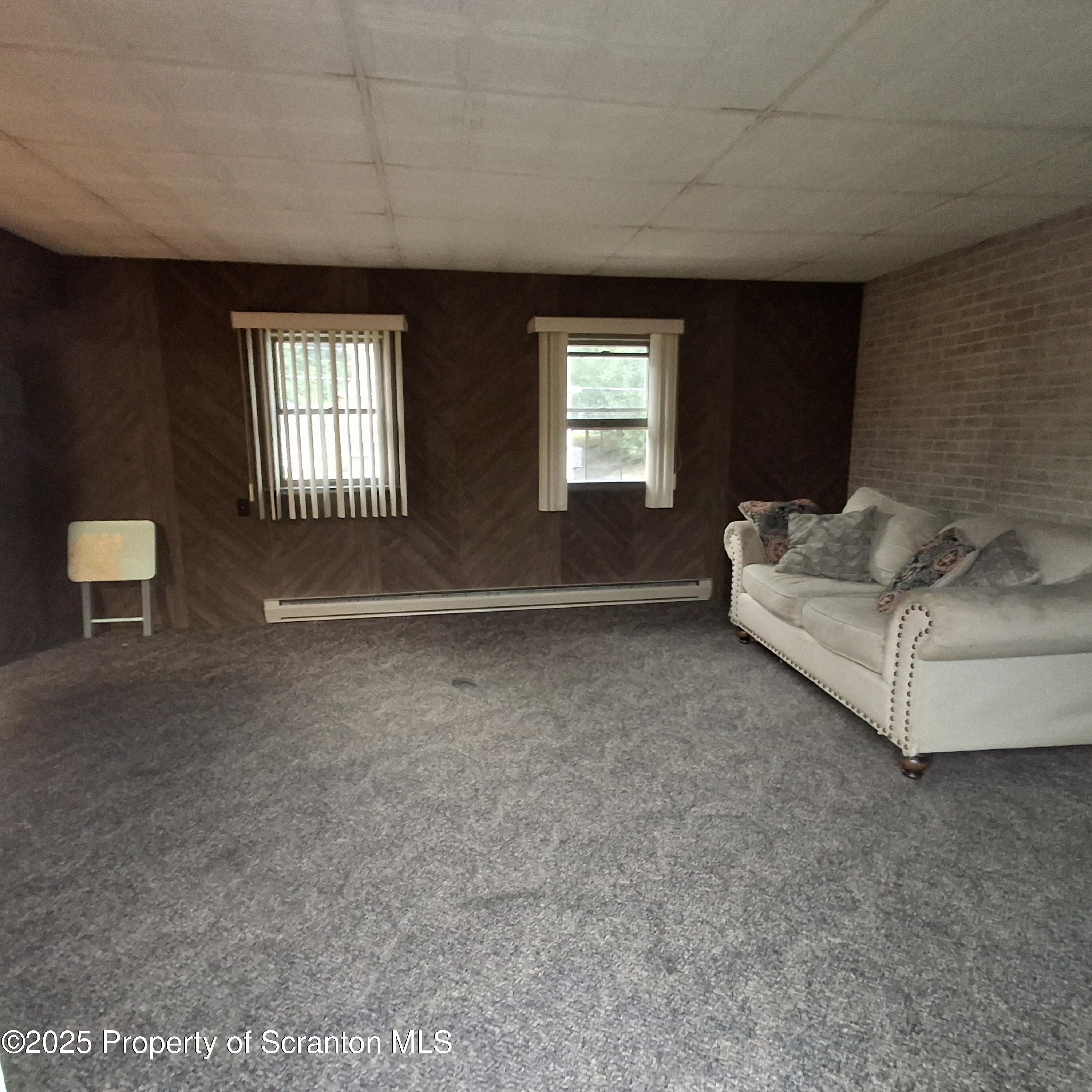 200 Poplar Street, Unit L 6 Archbald, PA 18403 - Photo 14 of 28 a living room with furniture and a window