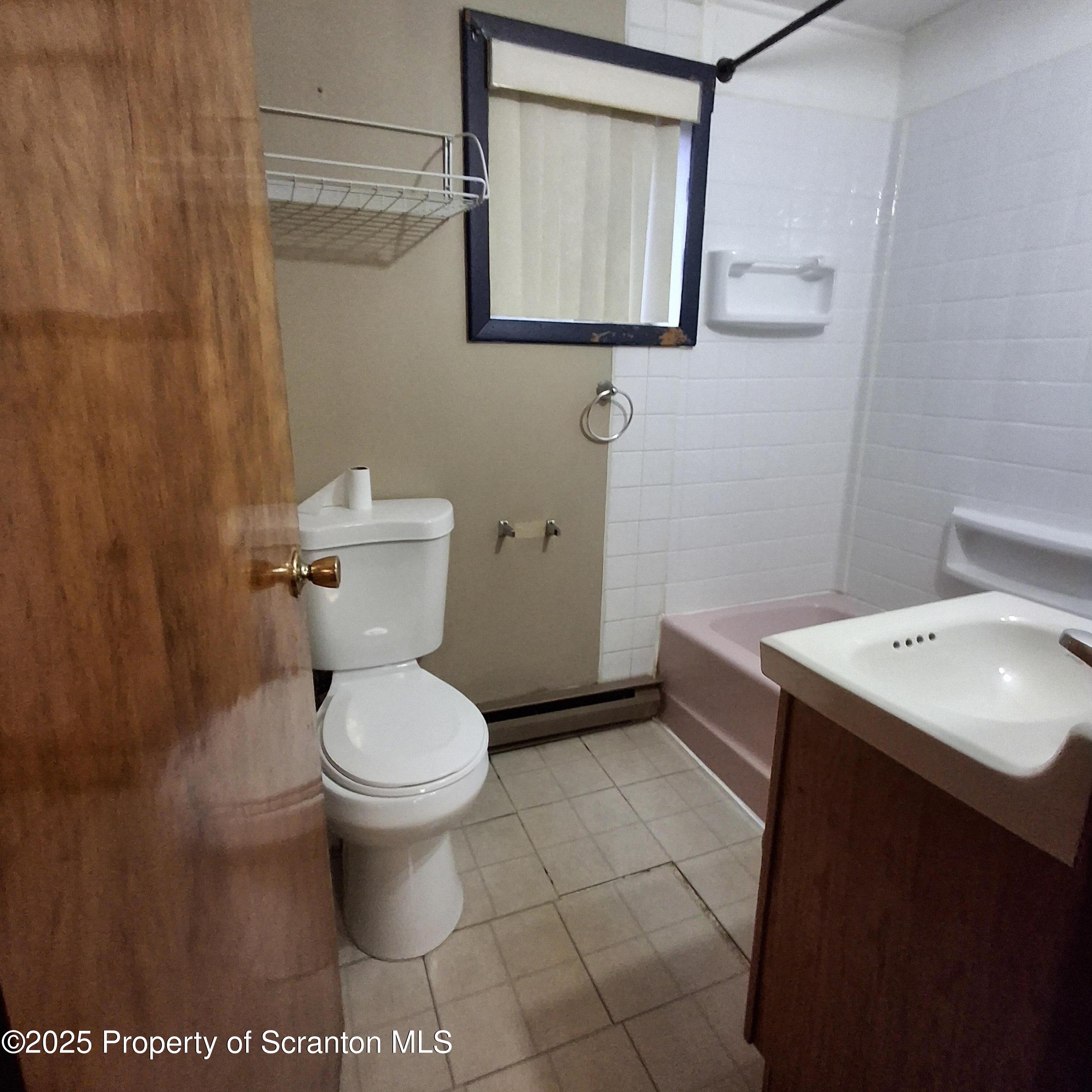 200 Poplar Street, Unit L 6 Archbald, PA 18403 - Photo 17 of 28 a bathroom with a toilet sink and mirror