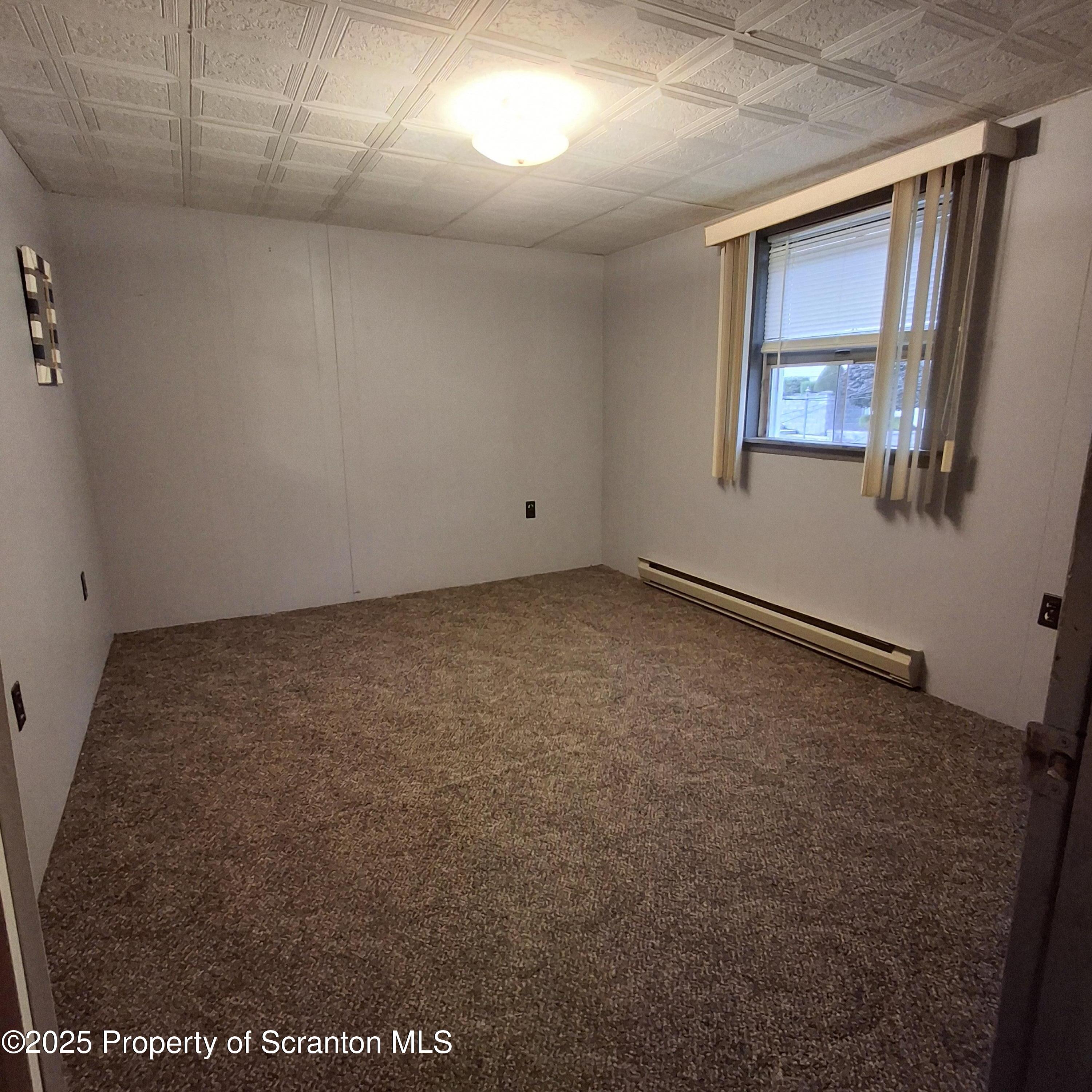 200 Poplar Street, Unit L 6 Archbald, PA 18403 - Photo 19 of 28 an empty room with a workbench