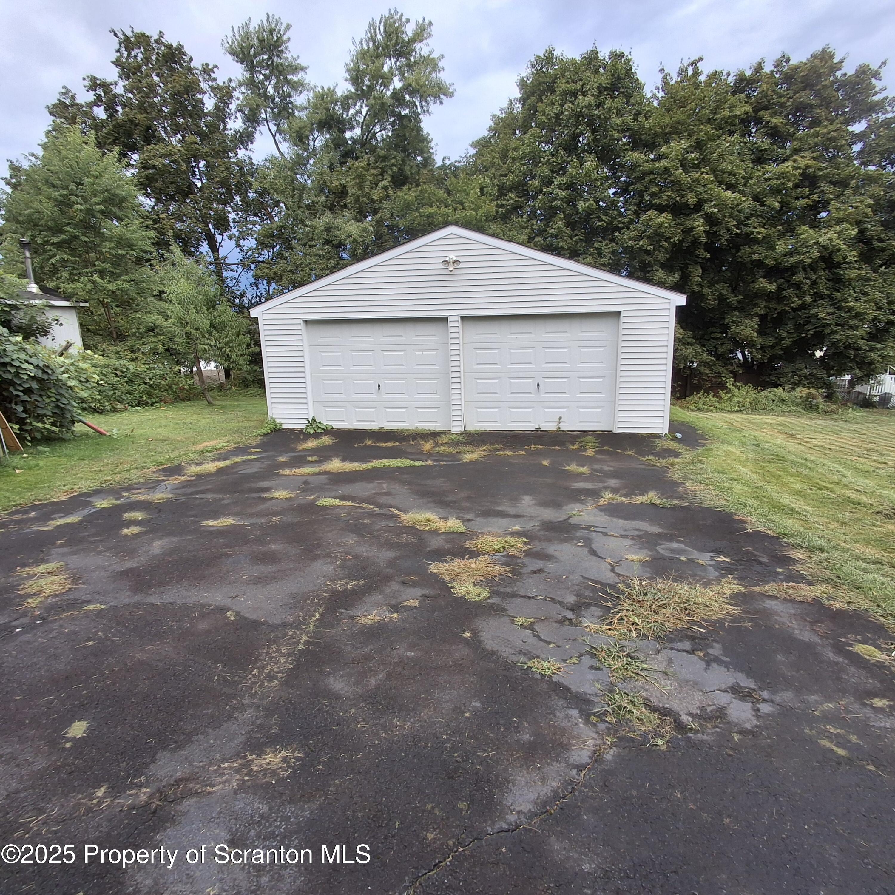 200 Poplar Street, Unit L 6 Archbald, PA 18403 - Photo 24 of 28 a front view of a house with a yard and garage