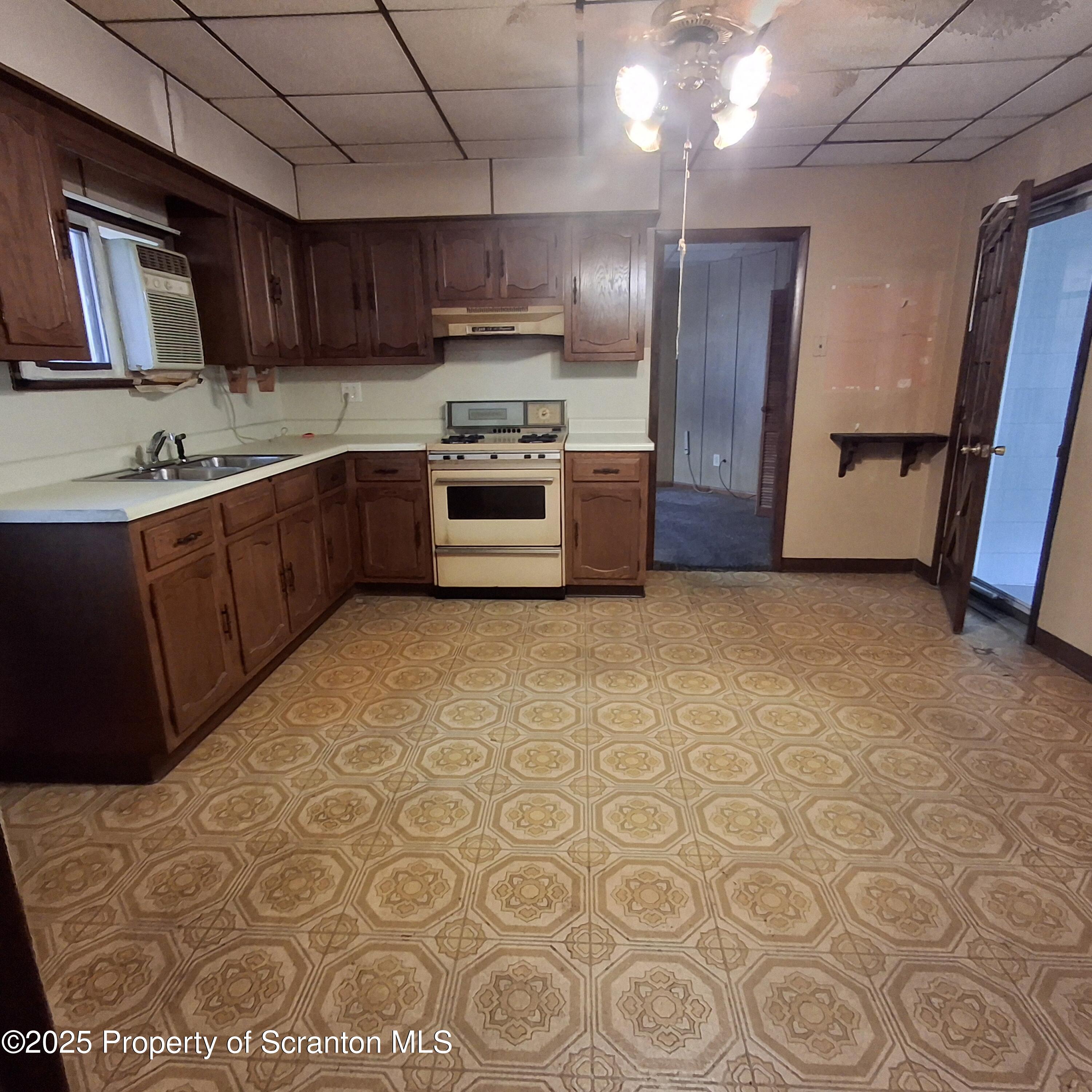 200 Poplar Street, Unit L 6 Archbald, PA 18403 - Photo 3 of 28 a kitchen with stainless steel appliances granite countertop a sink a stove a refrigerator cabinets and wooden floor
