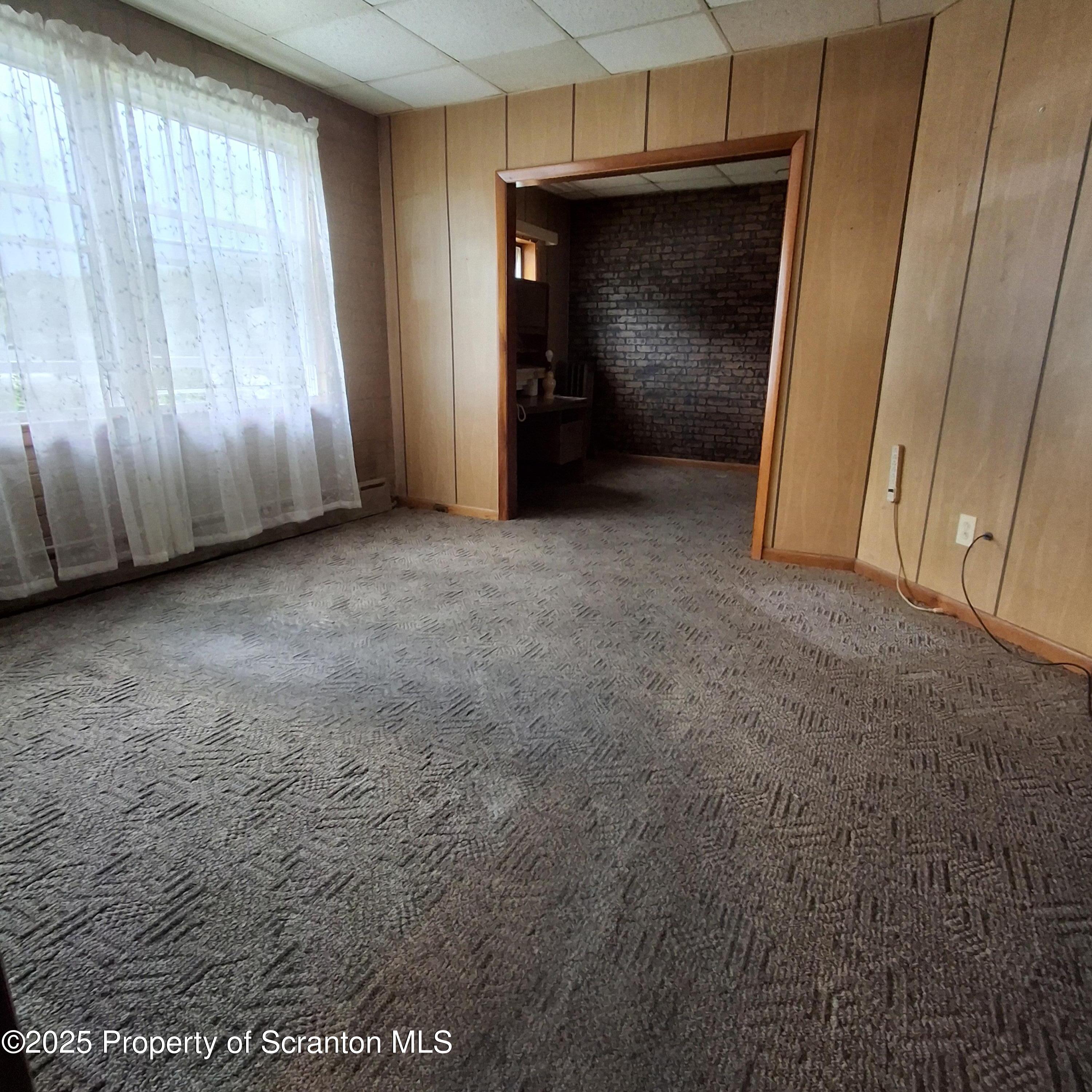 200 Poplar Street, Unit L 6 Archbald, PA 18403 - Photo 7 of 28 a view of an empty room with wooden floor and a cabinet