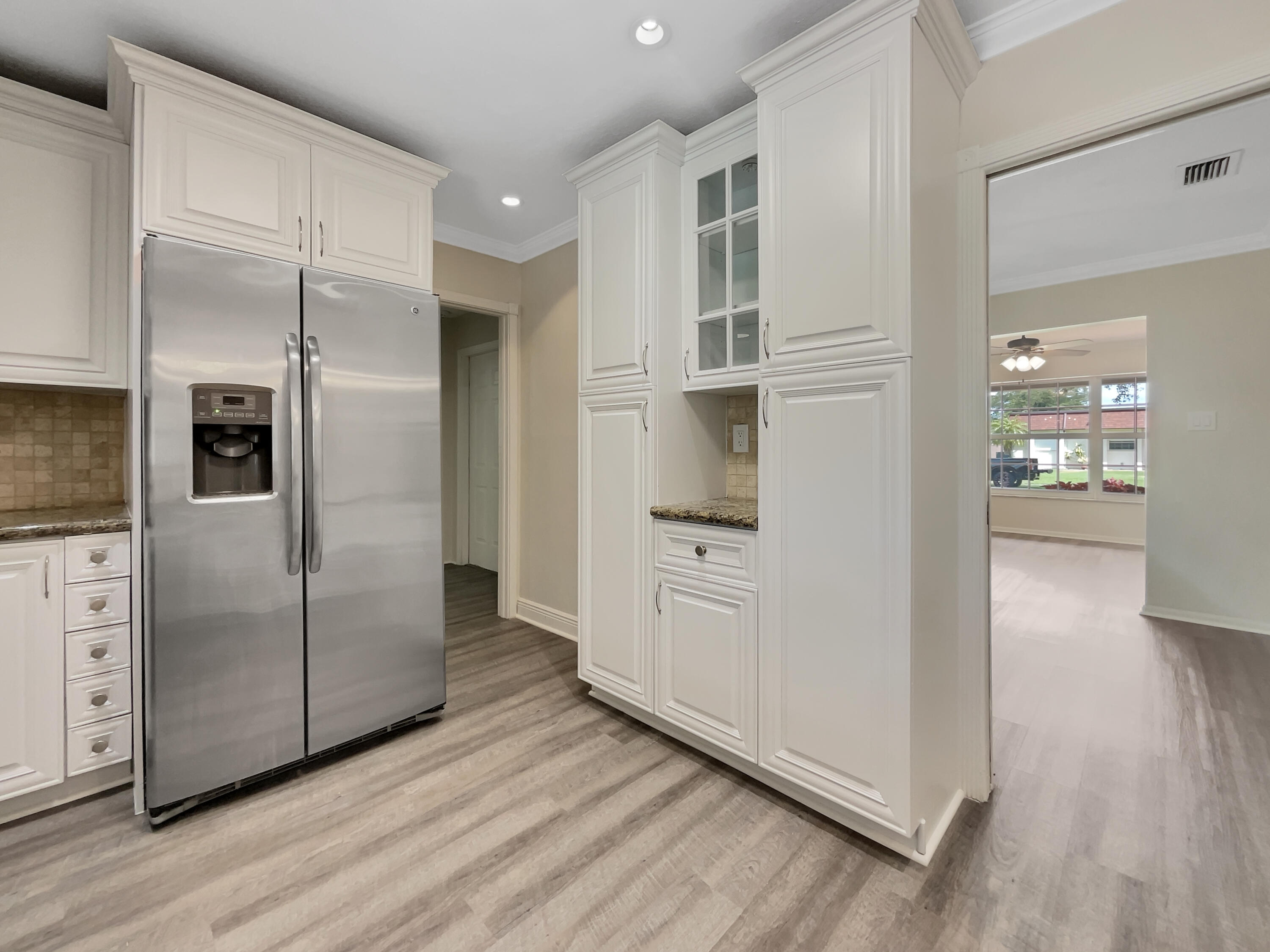 7480 Northwest 13th Court Plantation, FL 33313 - Photo 14 of 28 a kitchen with stainless steel appliances a refrigerator and wooden floor