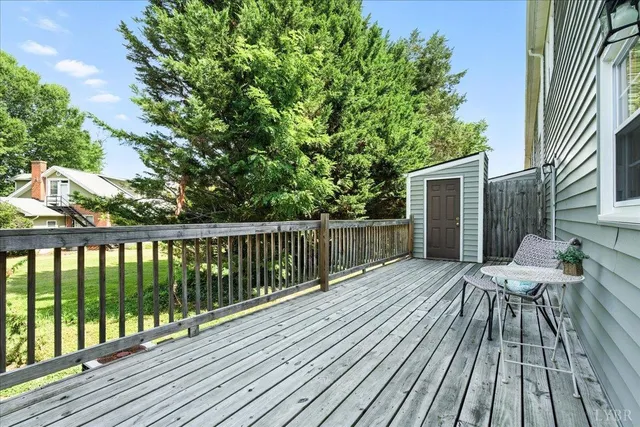a wooden bench sitting in front of a house