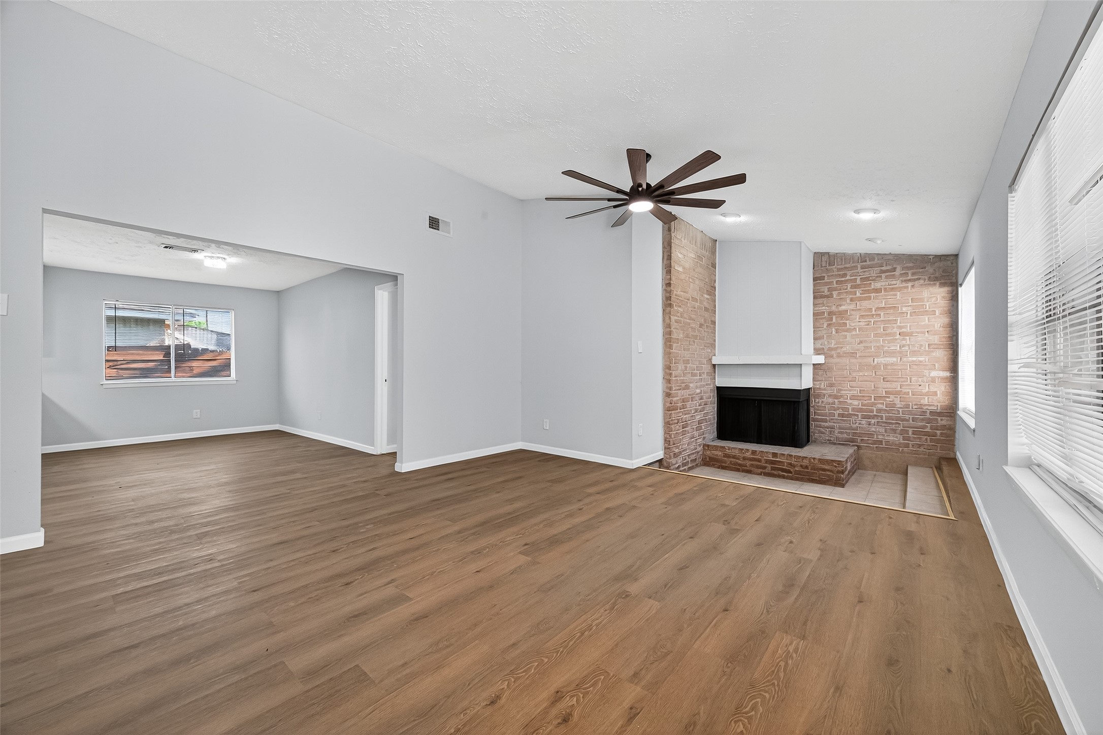 11622 Old Telegraph Road Houston, TX 77067 - Photo 12 of 38 an empty room with wooden floor and fireplace