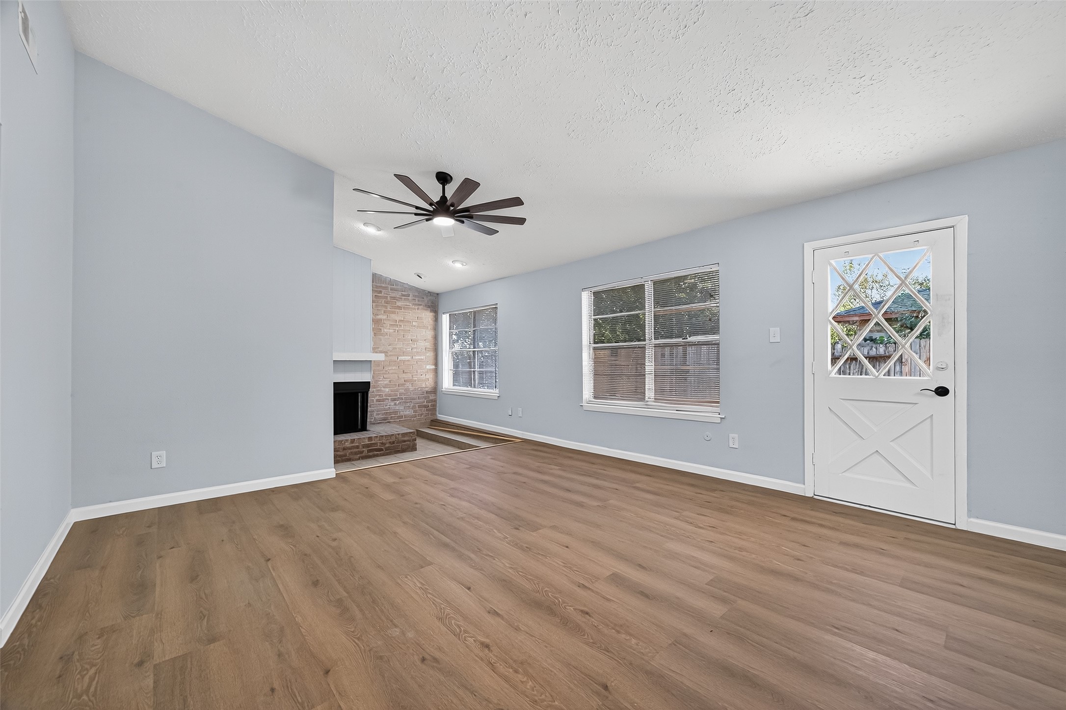 11622 Old Telegraph Road Houston, TX 77067 - Photo 13 of 38 a view of an empty room with a window and wooden floor