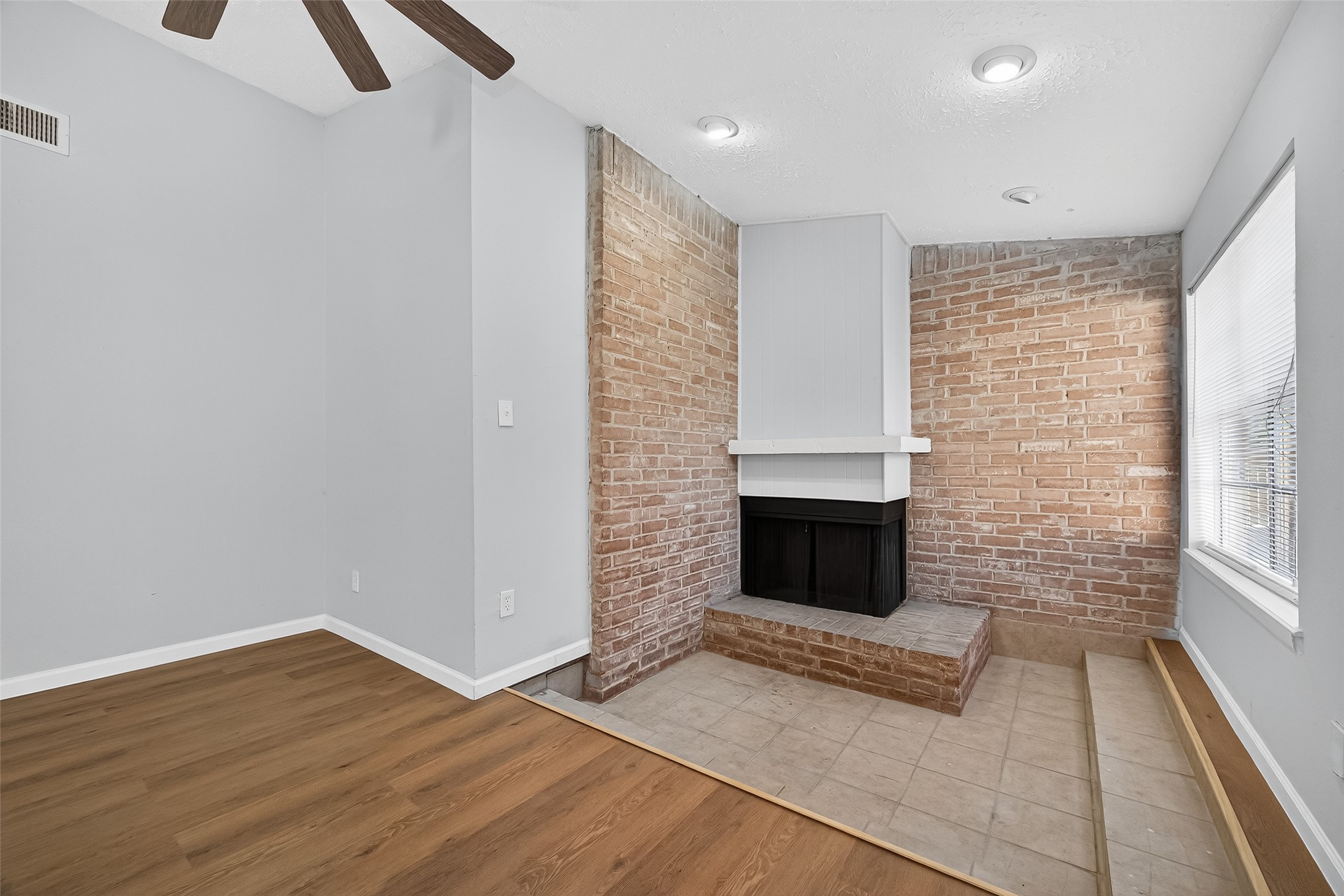 11622 Old Telegraph Road Houston, TX 77067 - Photo 14 of 38 a view of a livingroom with wooden floor and a fireplace