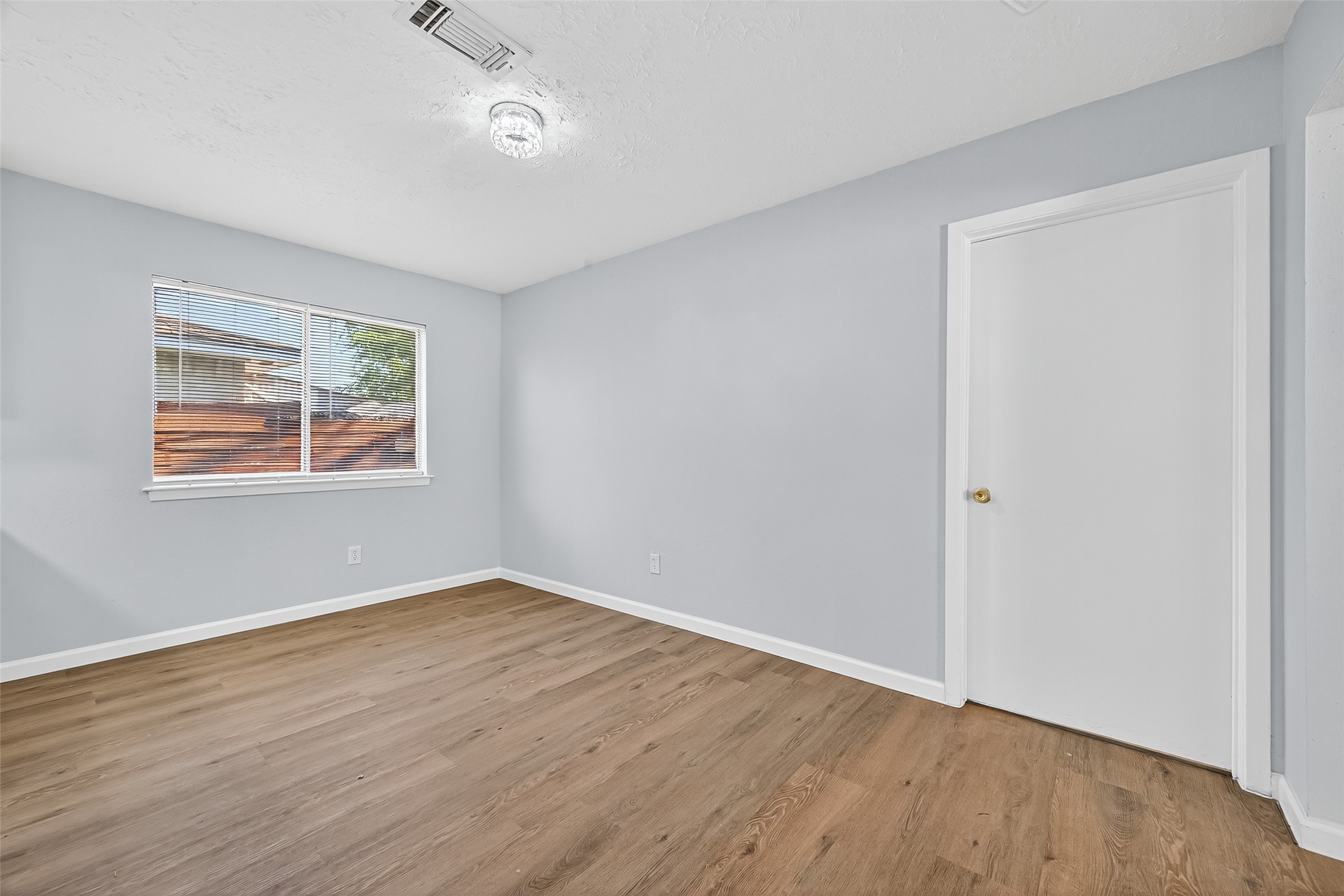 11622 Old Telegraph Road Houston, TX 77067 - Photo 16 of 38 an empty room with wooden floor ceiling fan and windows