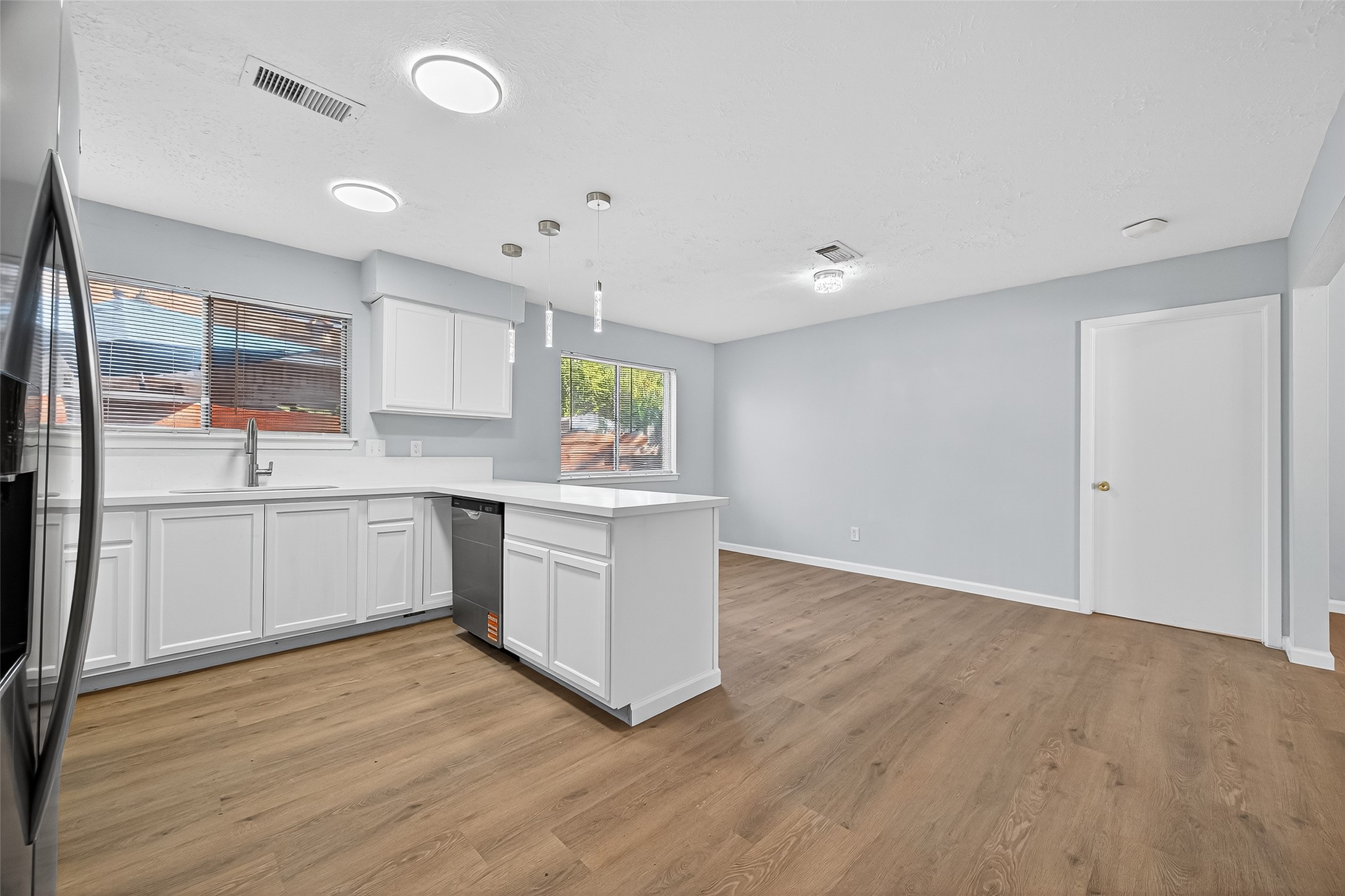 11622 Old Telegraph Road Houston, TX 77067 - Photo 23 of 38 a kitchen with wooden floors and white appliances