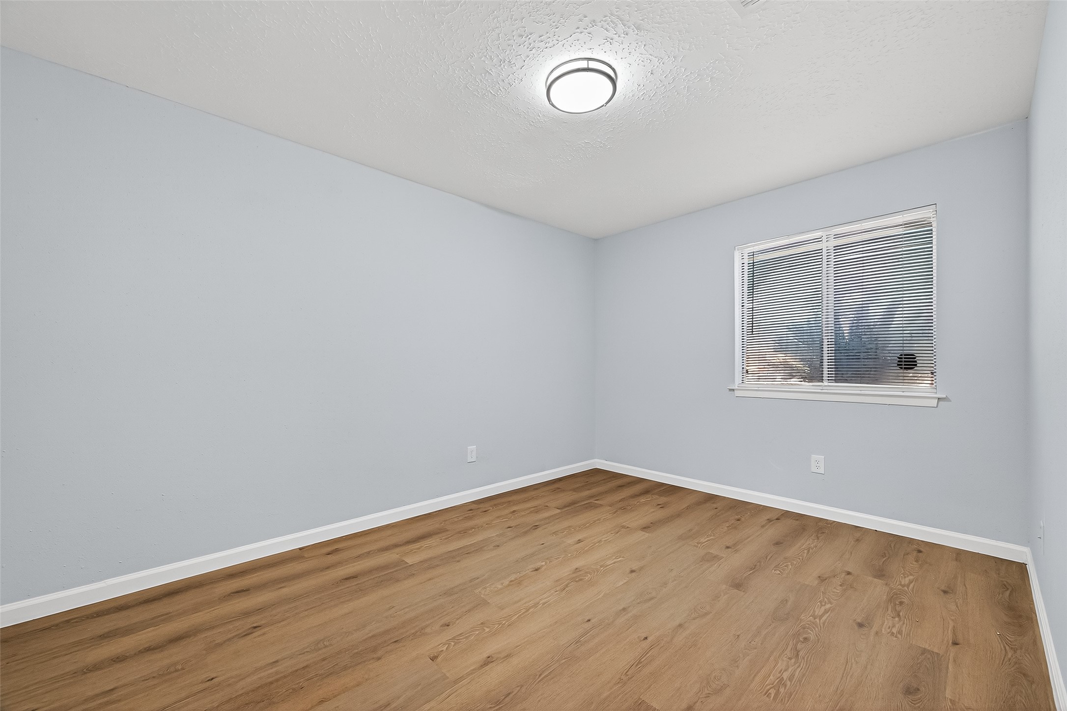 11622 Old Telegraph Road Houston, TX 77067 - Photo 28 of 38 an empty room with wooden floor and windows