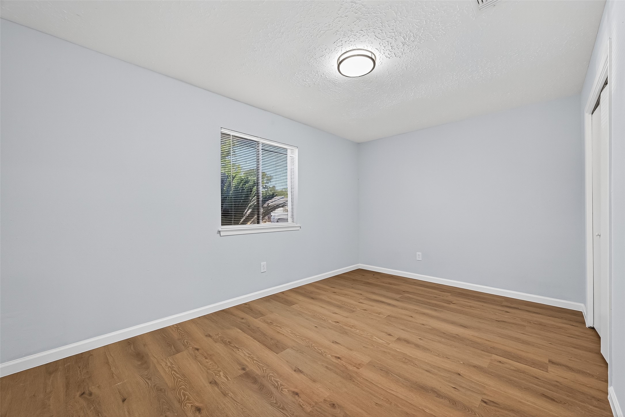 11622 Old Telegraph Road Houston, TX 77067 - Photo 31 of 38 an empty room with wooden floor and windows