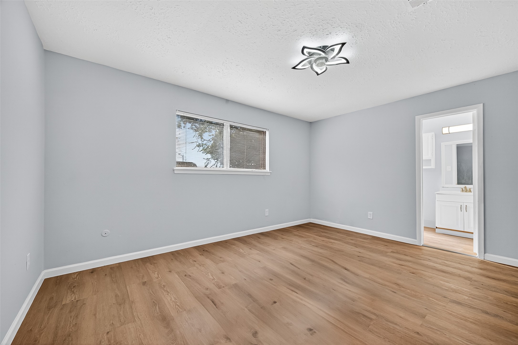 11622 Old Telegraph Road Houston, TX 77067 - Photo 35 of 38 a view of an empty room with wooden floor and a window